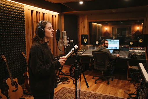 A vocalist recording in a professional music studio